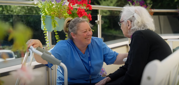 Chirk Court resident and staff member talking