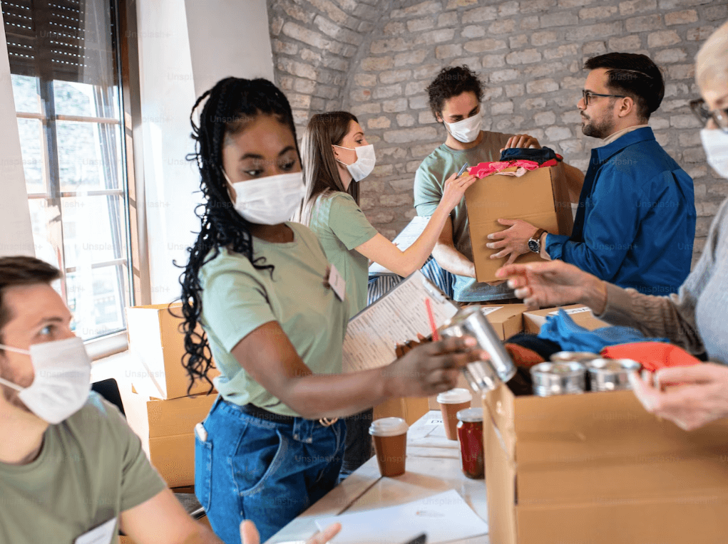 foodbank parcels being put together by a team of people wearing masks