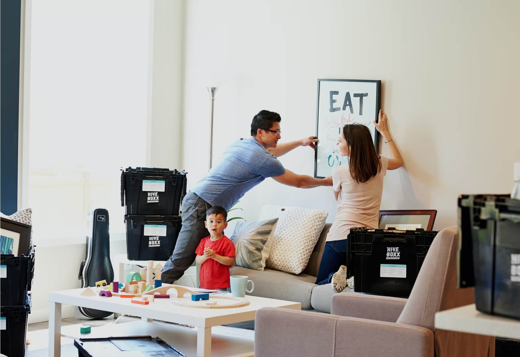 family redecorating home, hanging pictures together