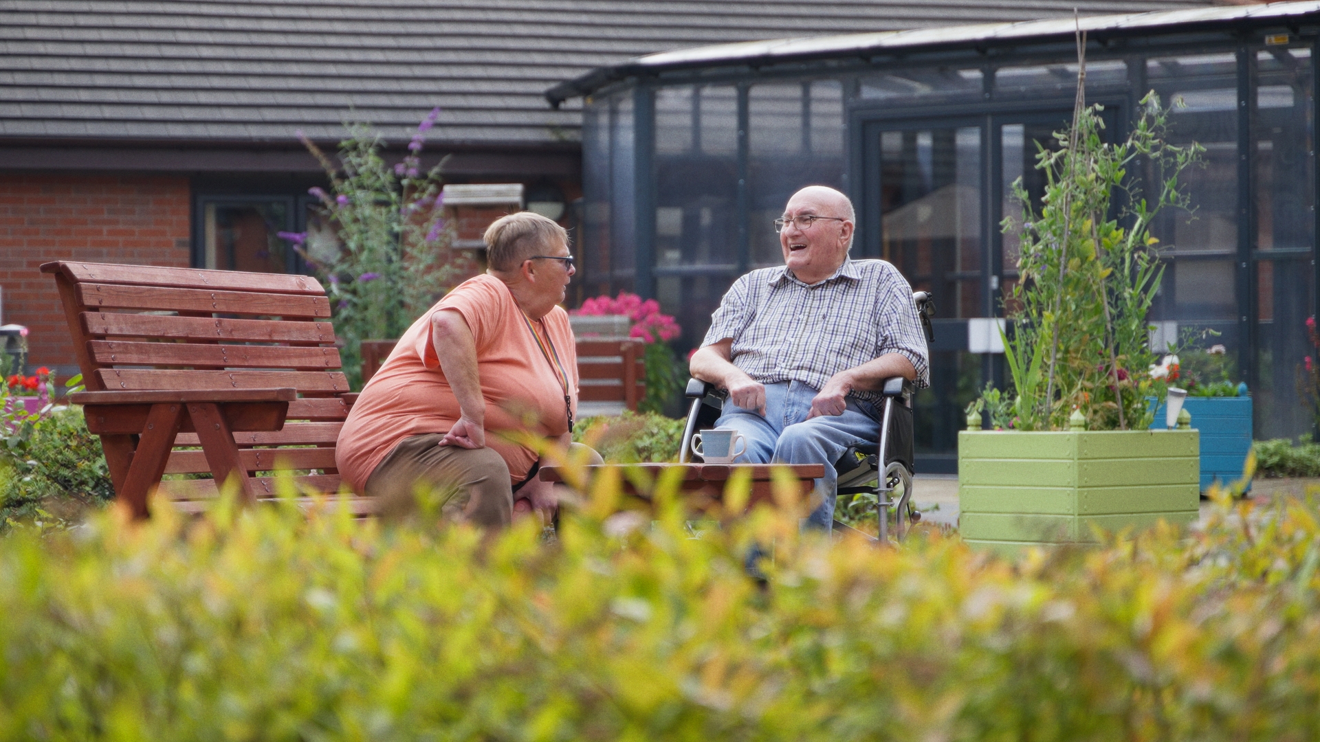 resident and staff member outside at Chirk Court Care Home