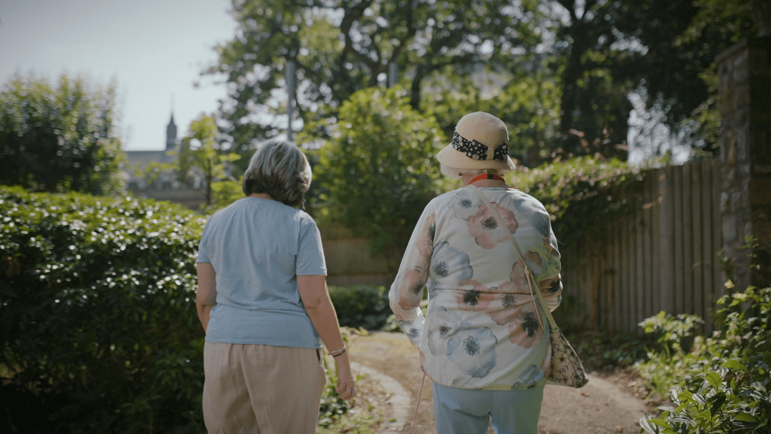 Resident and staff walking in Merton Place