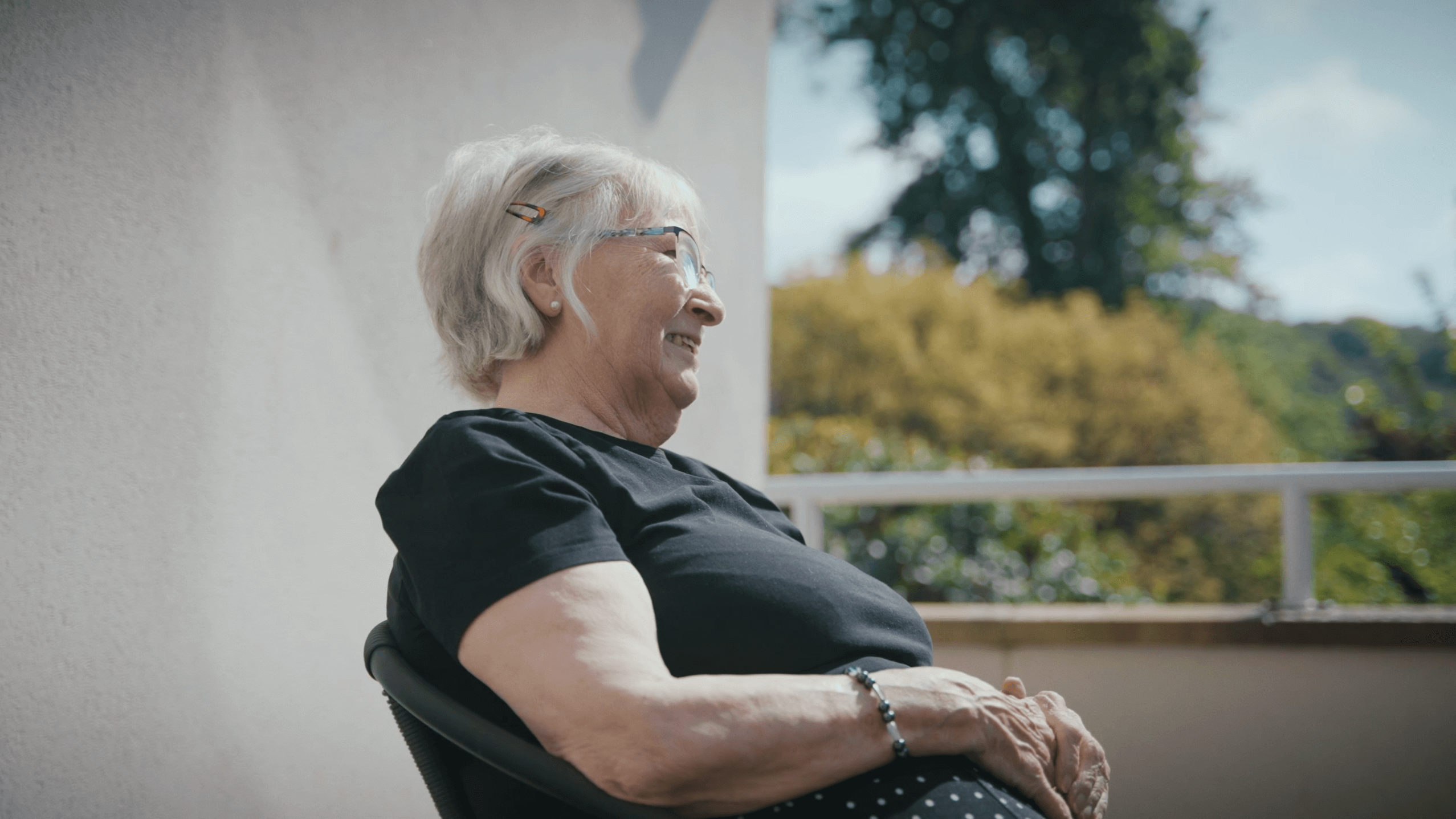 Resident sat outside relaxing at Merton Place 