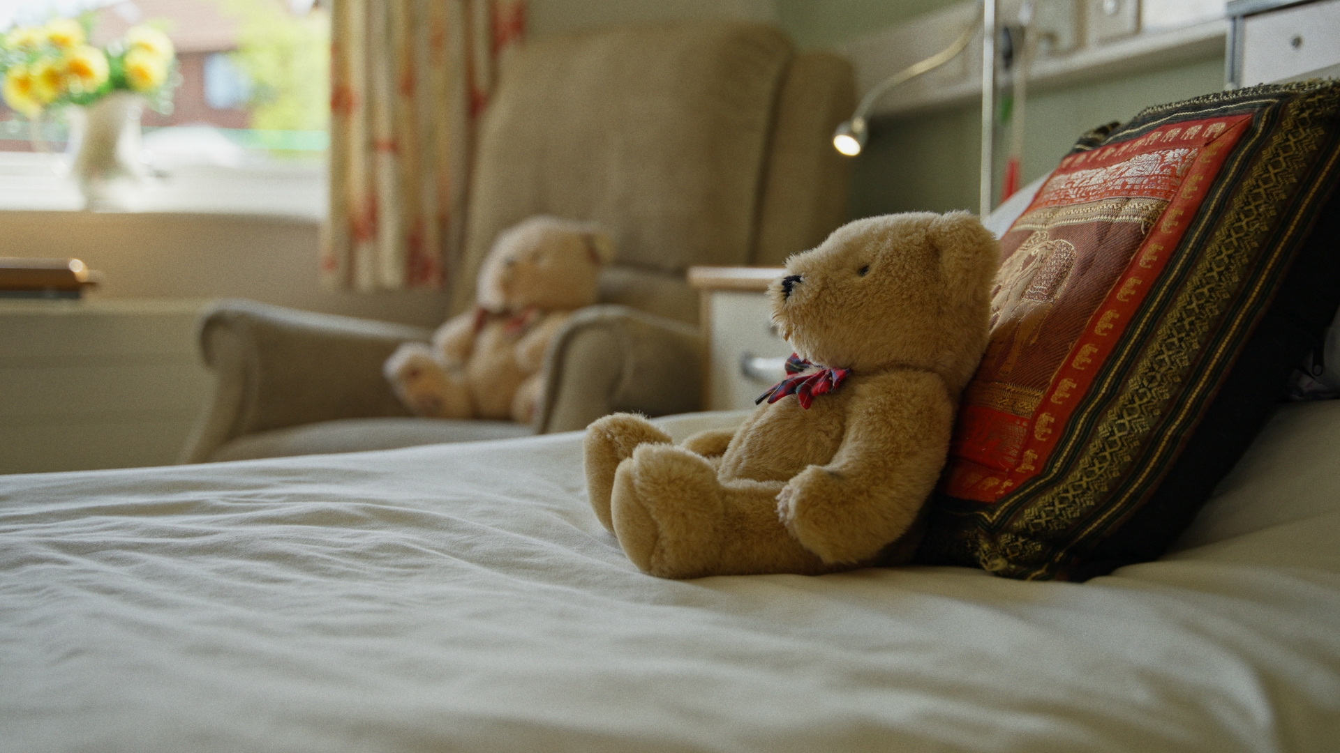 Bedroom with Teddy bear resting on bed at Chirk Court Wrexham
