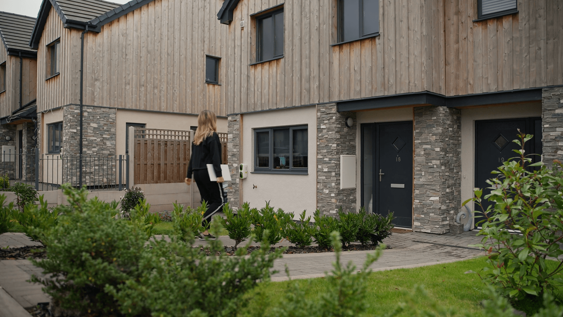 housing officer approaching a house