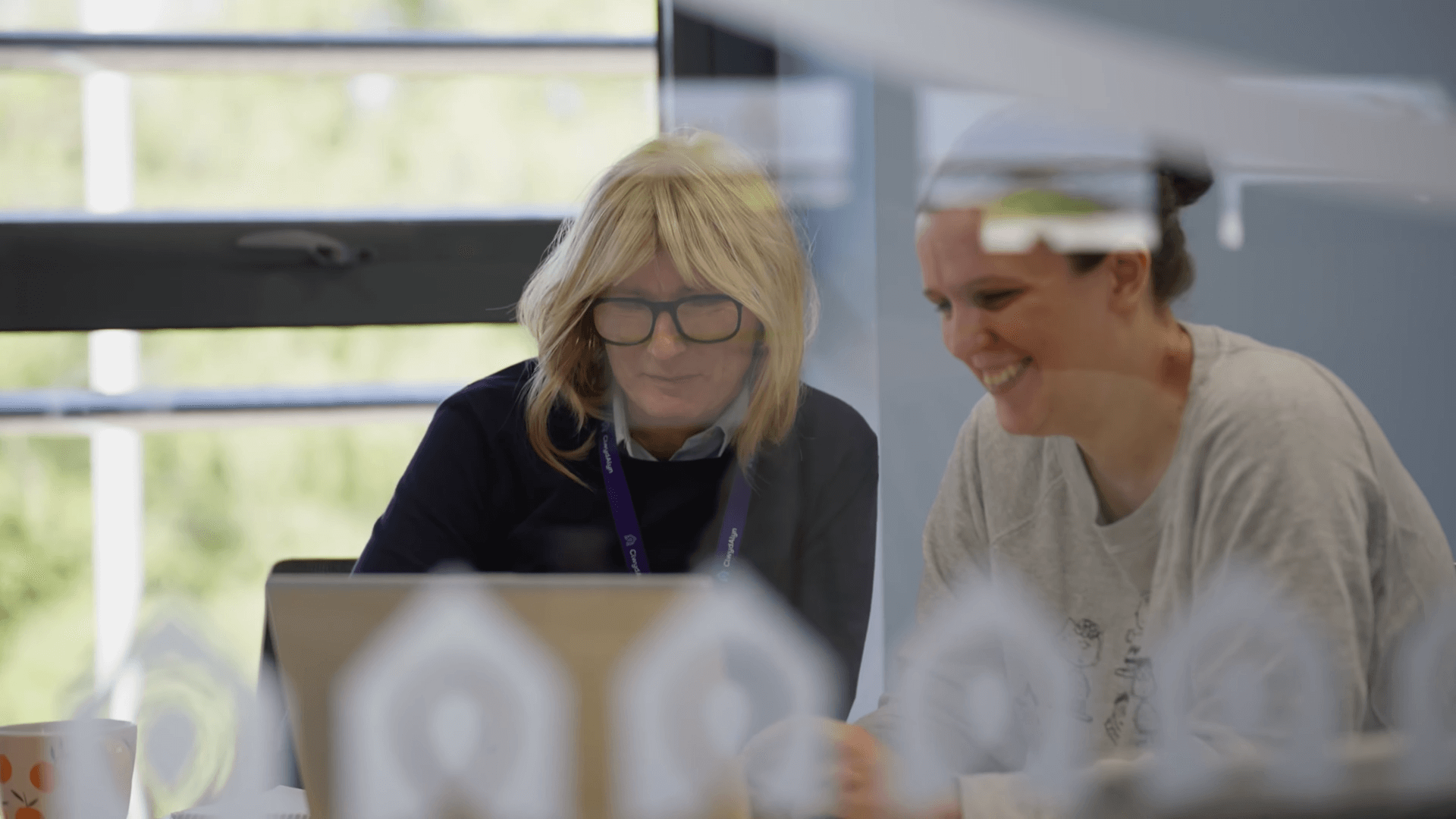 Staff collaborating on a laptop