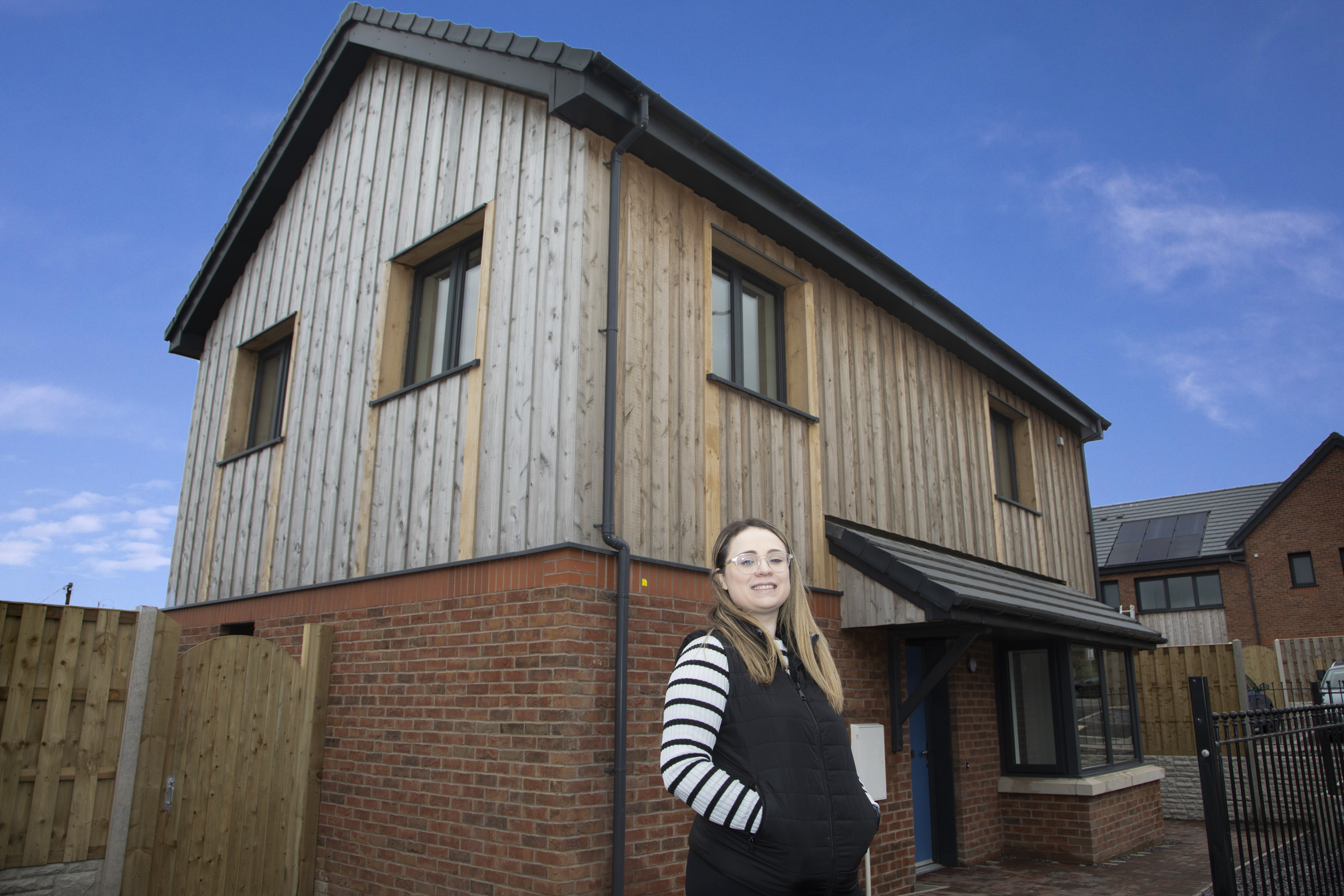 Resident stood outside new home at Hen ysgol y bont, Llangefni