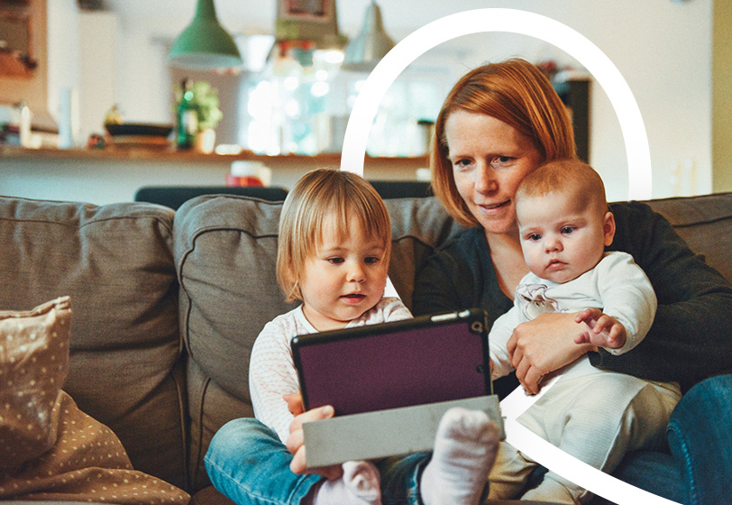 Image of mum with two children looking at a tablet device