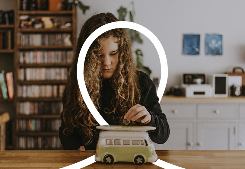 child putting penny in a camper van moneybox