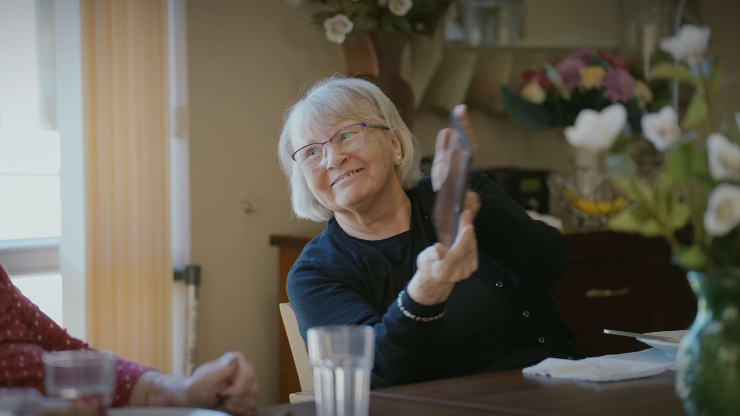 resident showing an image on a tablet in Chirk Court