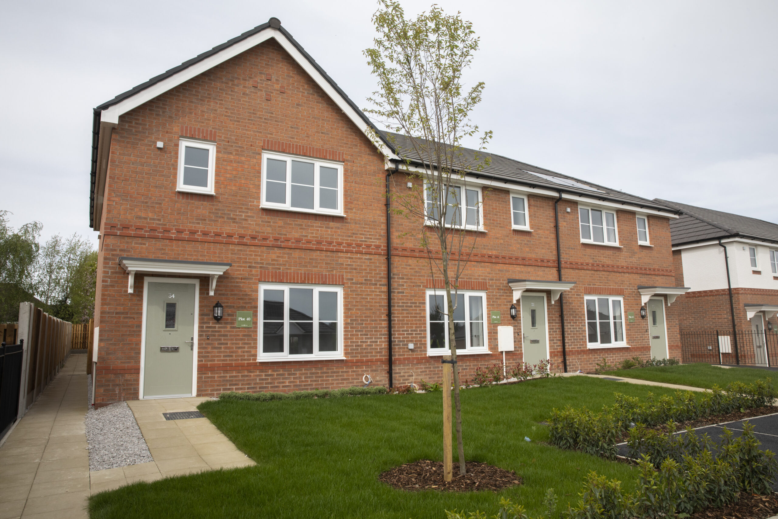 A terrace of new red-brick homes